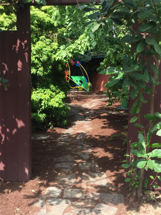 View of sculpture garden through the east gate | Russell McCormmach Sculpture Garden.