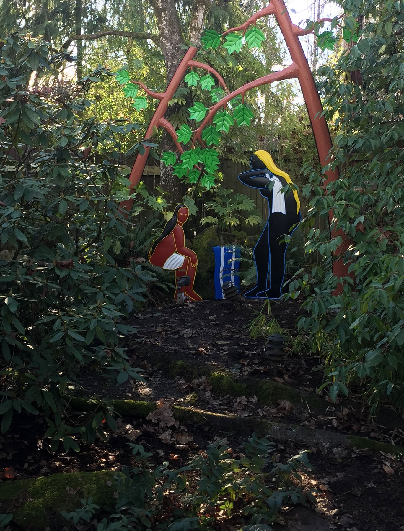 8c. Sculpture viewed from a distance. This is a summer scene, and in the summer in addition to the sculpted leaves, real leaves of neighboring maple trees are visible over the sculpture.