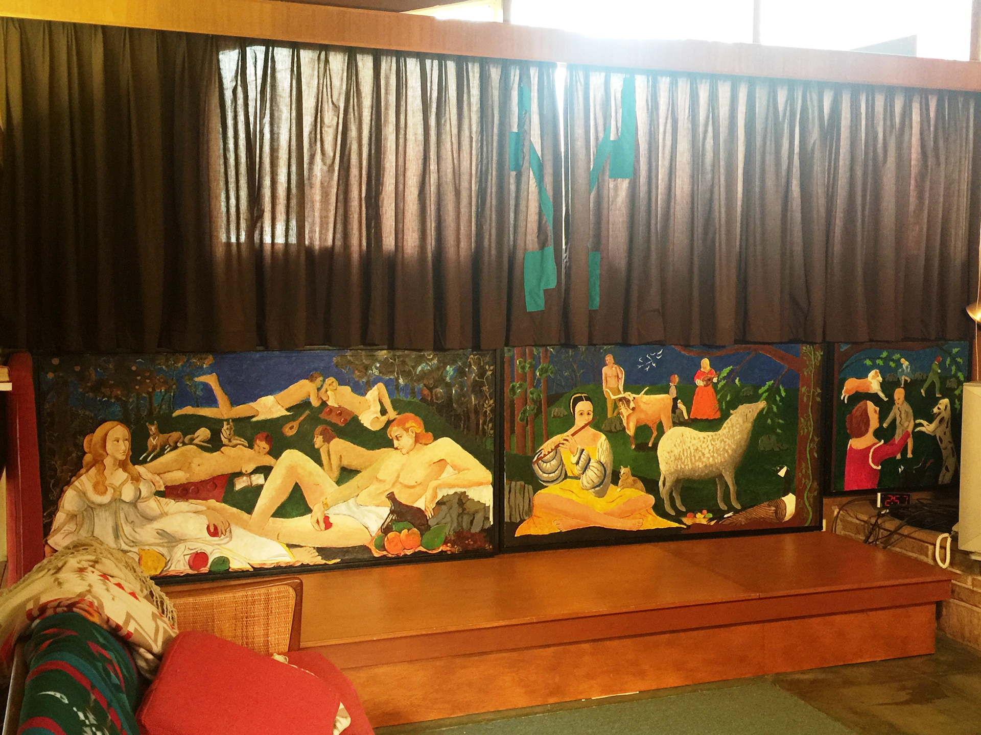 mural 1. Pleasures of a Summer Afternoon. 15’ x 3’. It’s an example of a practice of mine of occasionally including parts of well-known paintings in my compositions. The woman and man in the foreground on the left are Venus and Mars, love and war, borrowed from a painting by Botticelli. In the original, Mars is asleep, while satyrs make off with his weapon. In mine he is awake, gazing at Venus, a more likely reaction. The scene shows simple pleasures of an outing, true as well of our time as of Botticelli’s – making music, having conversation, sunbathing, reading, flirting, playing with children, running, letting pets roam, eating fruit, and drinking wine. On this website, I include separate photos of the three canvases, each of which is complete in itself, and of them together, as a single painting, in their permanent placement in the house.